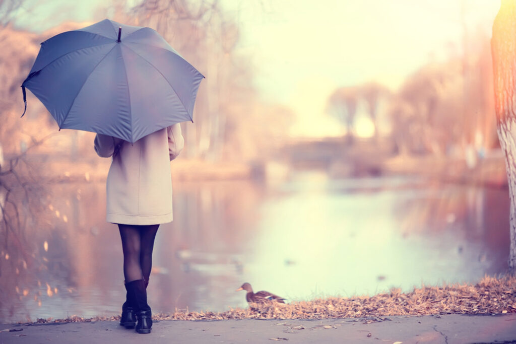 Lady With Umbrella Looking at Lake